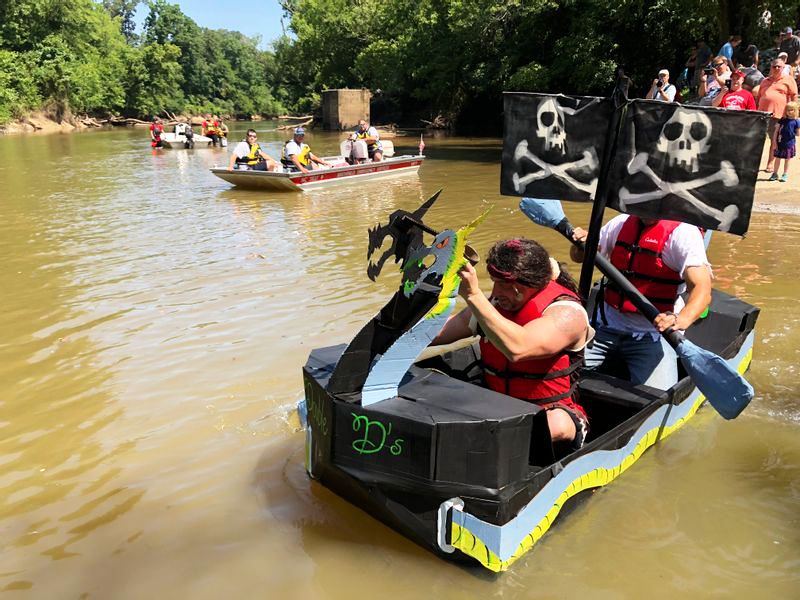 Participants in the River Rat Regatta, taking off at the boat ramp